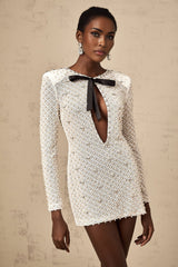 A white mini dress with cutout details and a decorative bowknot embellishment called Adalasia