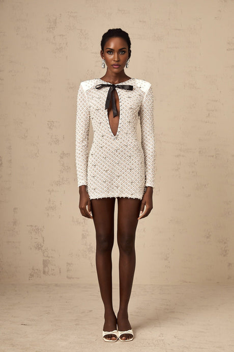A white mini dress with cutout details and a decorative bowknot embellishment named Adalasia