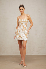 A white mini dress with floral applique details featuring a delicate Veronica flower design