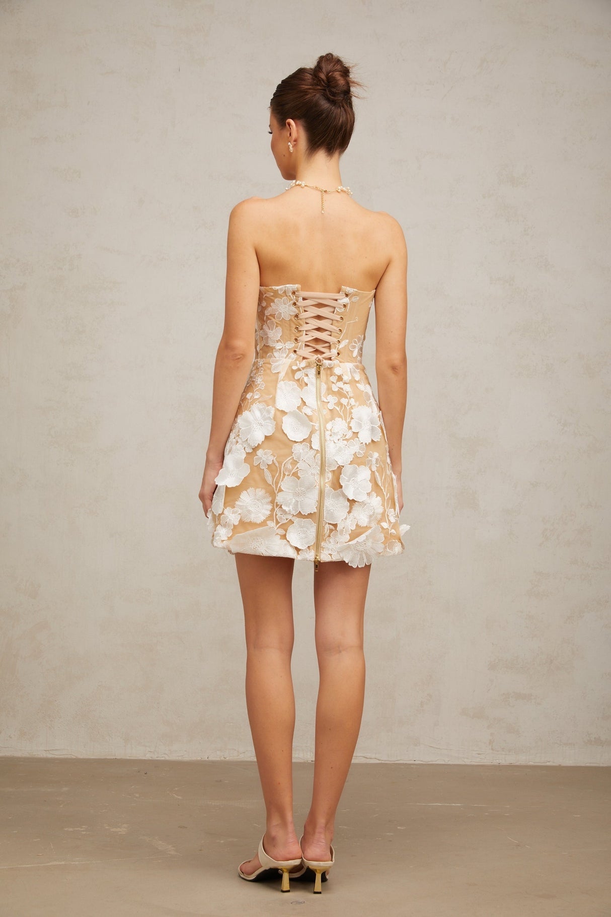 A white mini dress with floral appliques featuring a delicate Veronica flower design