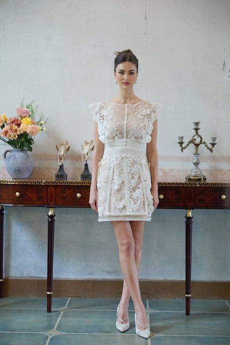 A white mini dress with floral embroidery and lace detailing Maïa style