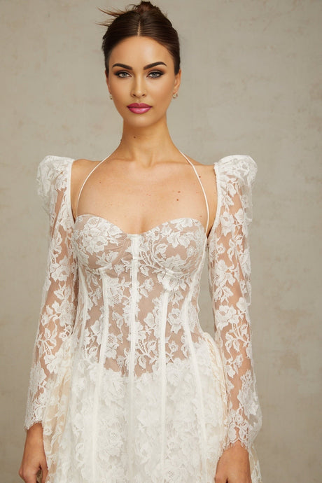 A white mini dress with floral lace detailing and a corset style bodice featuring the Vivienne design