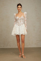 A white mini dress with floral lace detailing and a corset style bodice featuring the Vivienne design