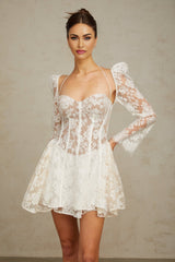 A white mini dress with floral lace detailing and a corsetstyle bodice featuring the Vivienne design