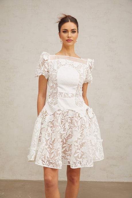 A white mini dress with floral lace pattern and puff sleeves in a romantic Josette style