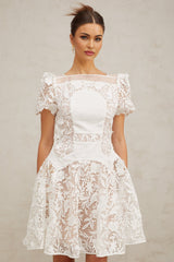 A white mini dress with floral lace pattern and puff sleeves Josette style short dress with feminine details