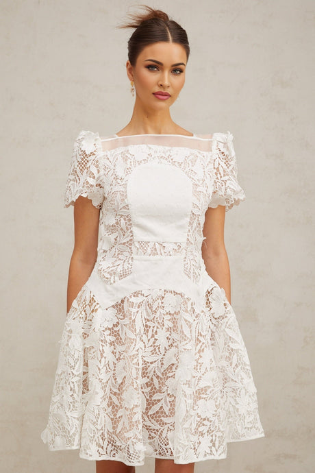 A white mini dress with floral lace pattern and puff sleeves Josette style short dress with feminine details