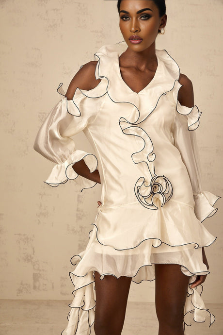 A white mini dress with flounce details and ribbon accents named Tiphaine featuring a short hemline and feminine design
