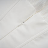 A white mini dress with full pleating and a cinched waist featuring a rosier design