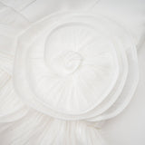 A white mini dress with full pleats and a cinched waist design featuring a rosier style and short length