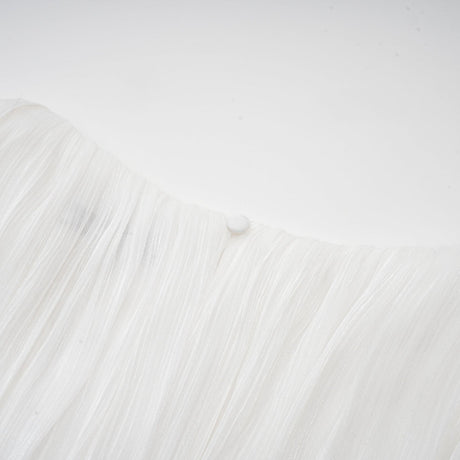 A white mini dress with full pleats and a cinched waist detail featuring a rosier design