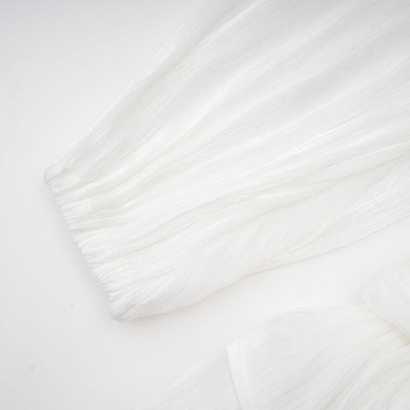 A white mini dress with full pleats and a cinched waist featuring a rosier design