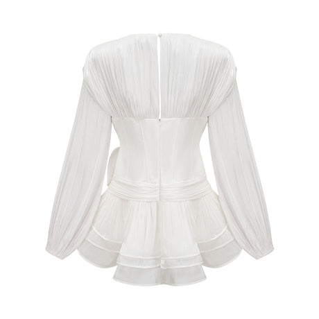 A white mini dress with full pleats and a cinched waist featuring a rosier design