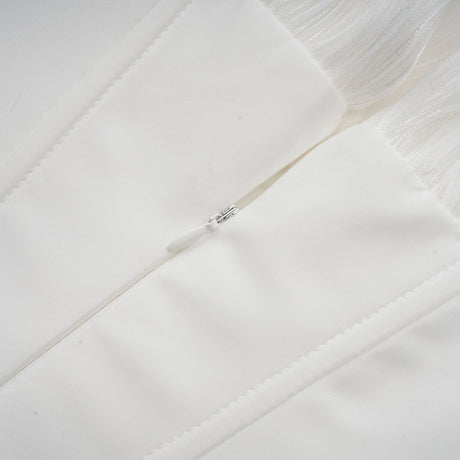 A white mini dress with full pleats and a cinched waist featuring a rosier style design