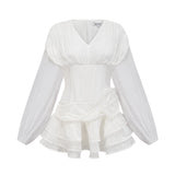 A white mini dress with full pleats and a cinched waist featuring a rosier style design