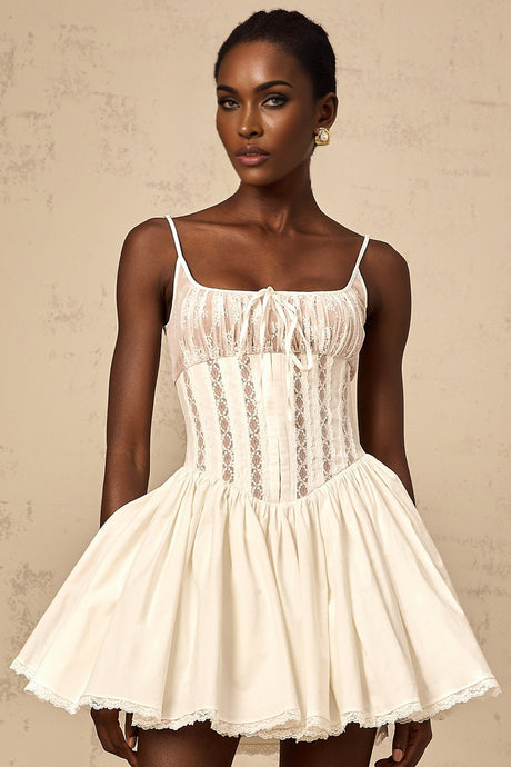 A white mini dress with lace details and a corsetstyle bodice featuring a fitted silhouette and short length