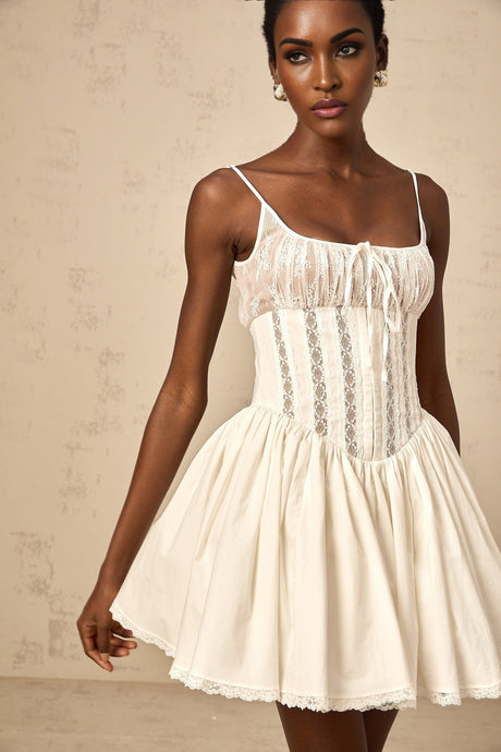 A white mini dress with lace details and a corsetstyle bodice featuring a fitted silhouette and short length