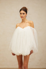 A white mini dress with layered bubble tulle skirt featuring a fitted bodice and short length named Avril