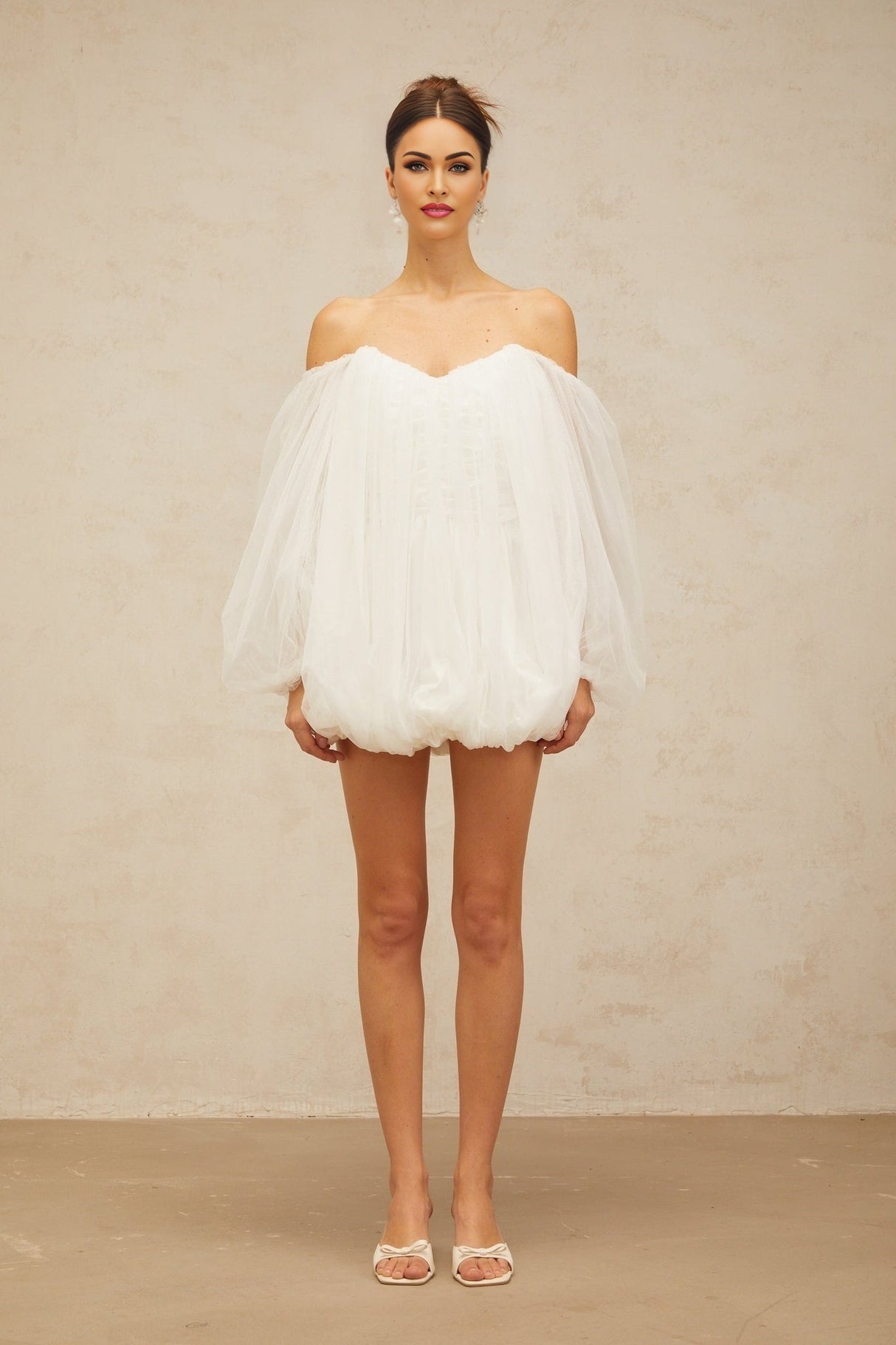 A white mini dress with layered bubble tulle skirt named Avril featuring a short length and voluminous texture