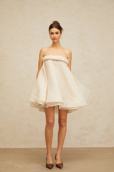 A white mini dress with puffed sleeves and braided details named Violette
