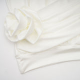 A white mini dress with ruched detailing and faux flower embellishments named Maeva