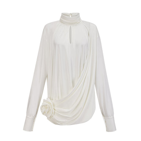 A white mini dress with ruched detailing and faux flower embellishments on a female model