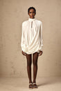 A white mini dress with ruched detailing and faux flower embellishments