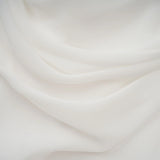 A white mini dress with ruched detailing and ribbon design accents featuring a fitted silhouette and short length