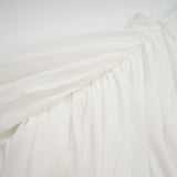 A white mini dress with ruched fabric and ribbon design details named Gitta