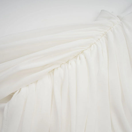 A white mini dress with ruched fabric and ribbon design details named Gitta