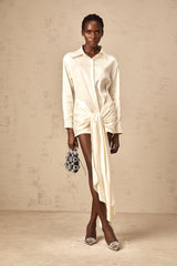 A white mini shirt dress with ruched detailing and a ribbon accent named Daphne
