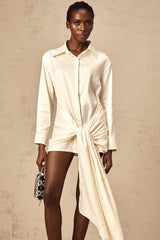 A white mini shirt dress with ruched detailing and ribbon accents named Daphne featuring a short length and feminine design