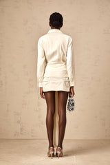 A white mini shirt dress with ruched detailing and ribbon accents named Daphne featuring a short length and fitted silhouette