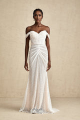 A white offshoulder maxi dress with embellishments worn by a model named Margot