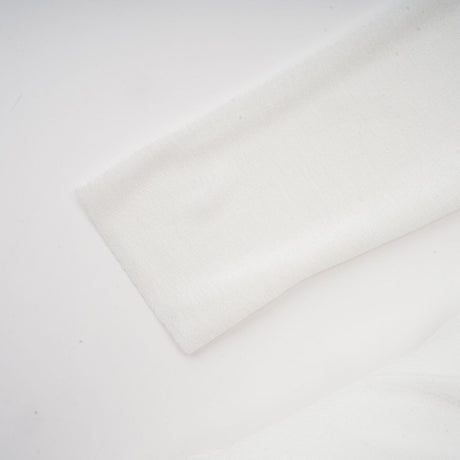A white offshoulder maxi dress with panel detailing worn by a model named Nadine
