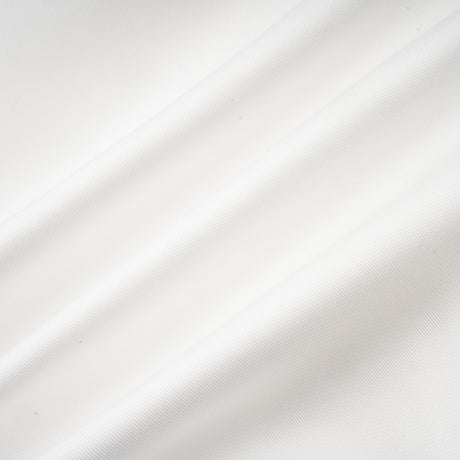 A white offshoulder maxi dress with panel detailing worn by a model standing against a plain background