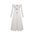 A white offshoulder maxi dress with panelled design worn by a model standing against a plain background