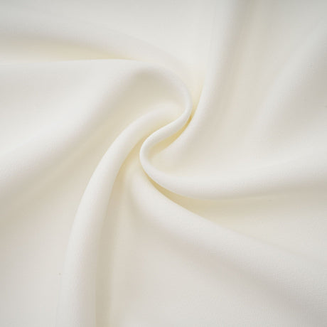 A white offshoulder maxi dress with pleated details worn by a model named Vanessa