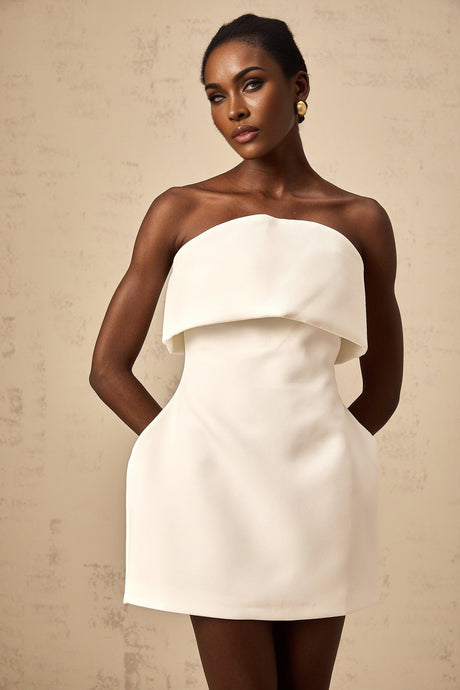 A white offshoulder mini dress with puff sleeves named Enora