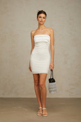 A white offshoulder mini dress with sequin embellishments on a female model