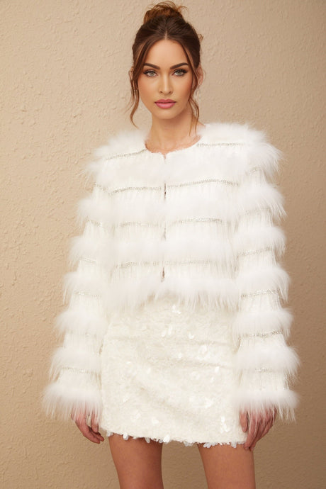 A white padded fur jacket adorned with crystal embellishments in a floral pattern named Margherita