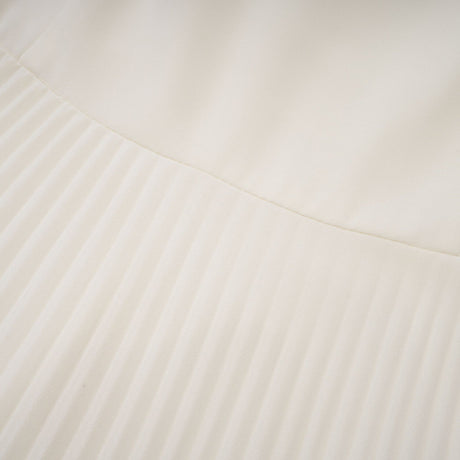 A white pleated jacket and dress set with embellishments The jacket features decorative details and the dress has a matching pleated design Both pieces are shown together as a coordinated outfit