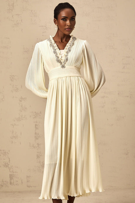A white pleated midi dress with crystal trim detailing along the neckline and waist named Yana