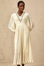 A white pleated midi dress with crystal trim detailing along the neckline and waist named Yana