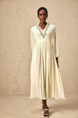 A white pleated midi dress with crystal trim detailing along the neckline and waist named Yana