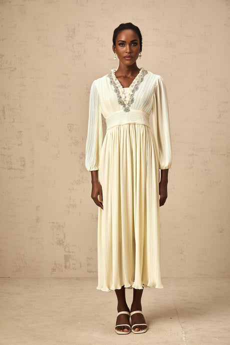 A white pleated midi dress with crystal trim detailing named Yana