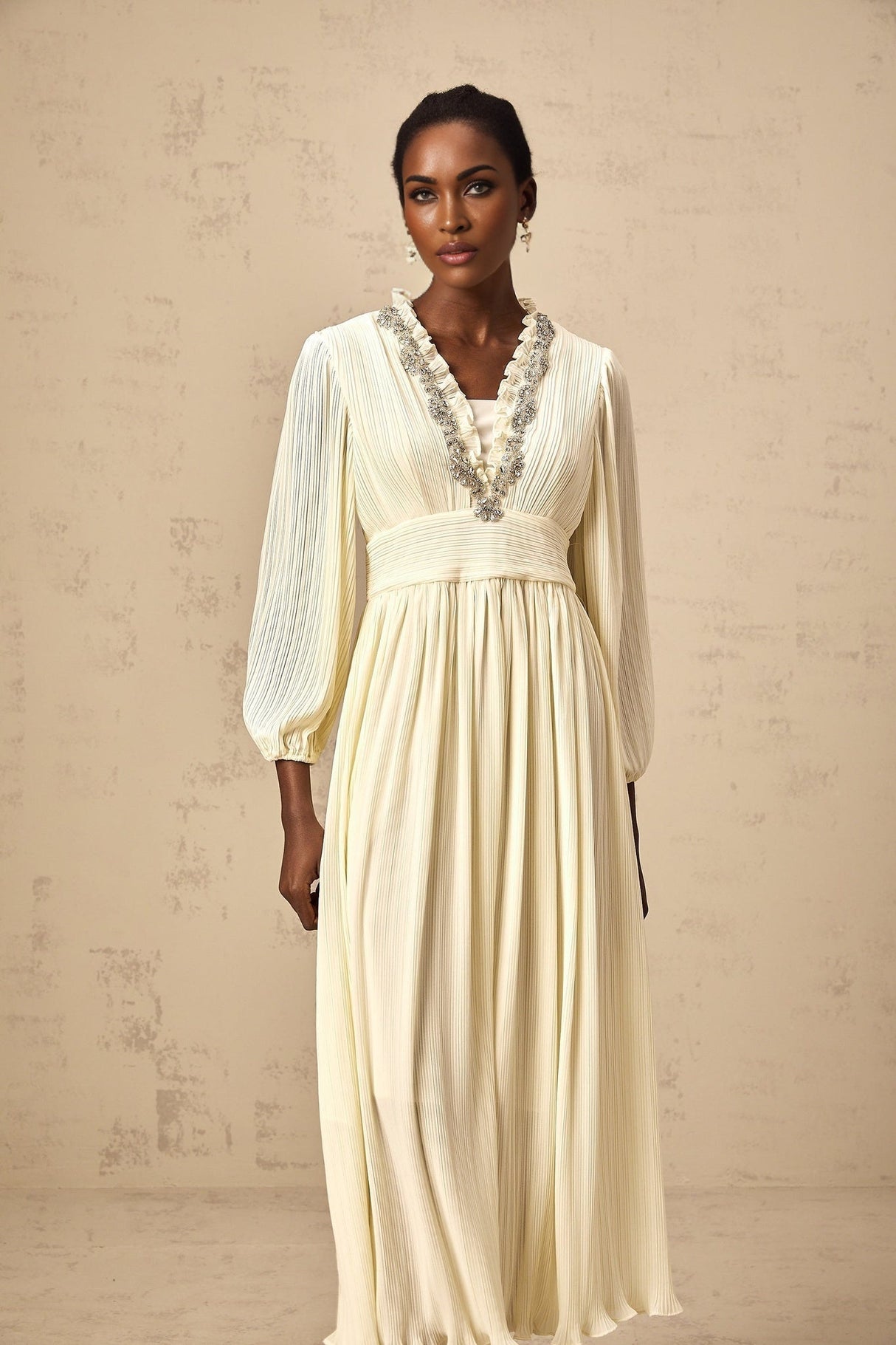 A white pleated midi dress with crystal trim detailing named Yana