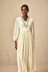 A white pleated midi dress with crystal trim detailing named Yana