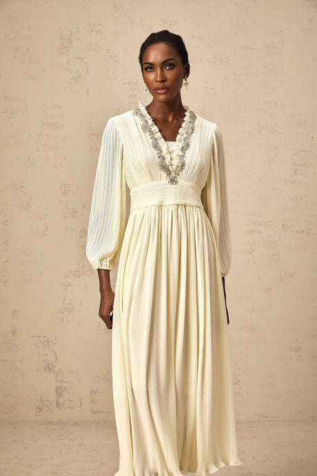 A white pleated midi dress with crystal trim detailing named Yana