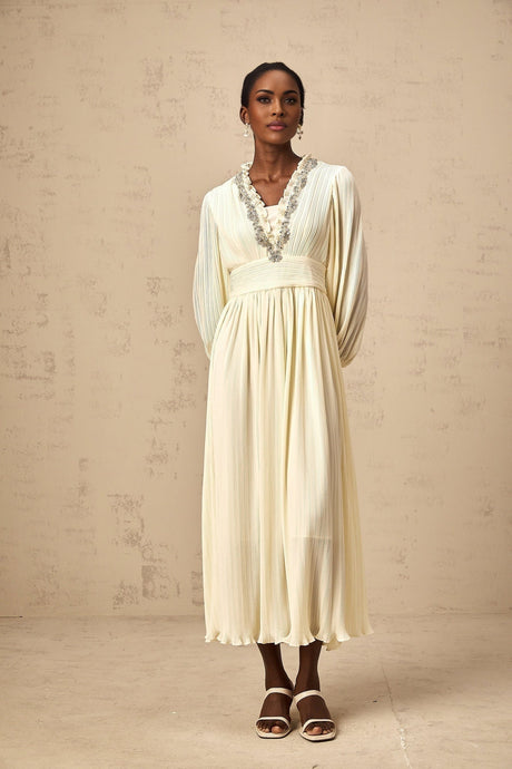 A white pleated midi dress with crystal trim detailing named Yana